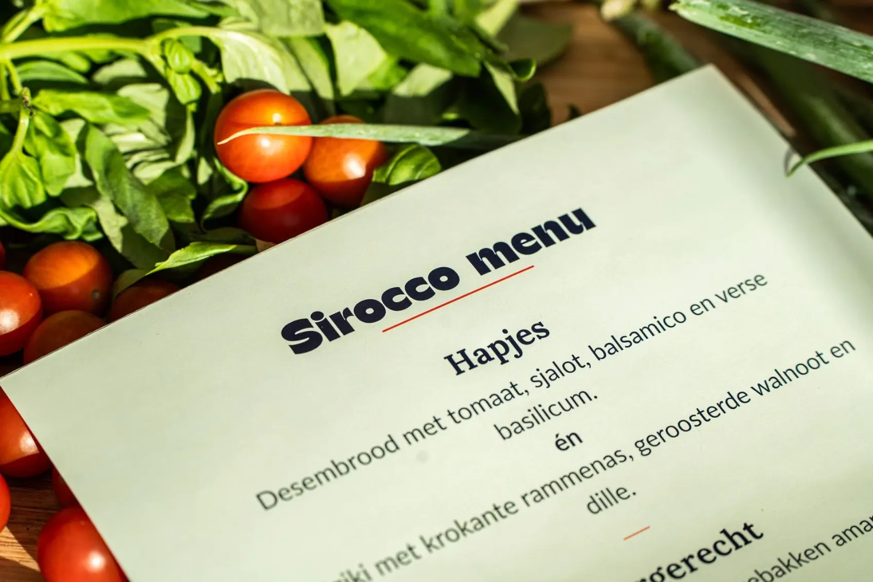Opperdash menu card among fresh tomatoes and basil